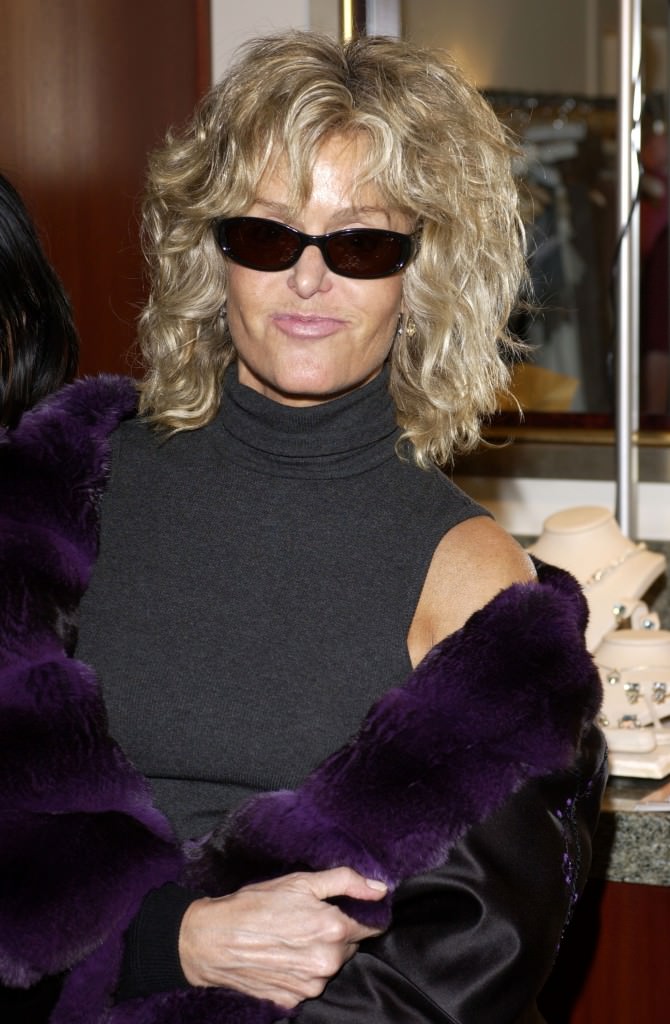 Farrah in a coat trimmed in luxurious deep purple fur Farrah in a coat trimmed in luxurious deep purple fur