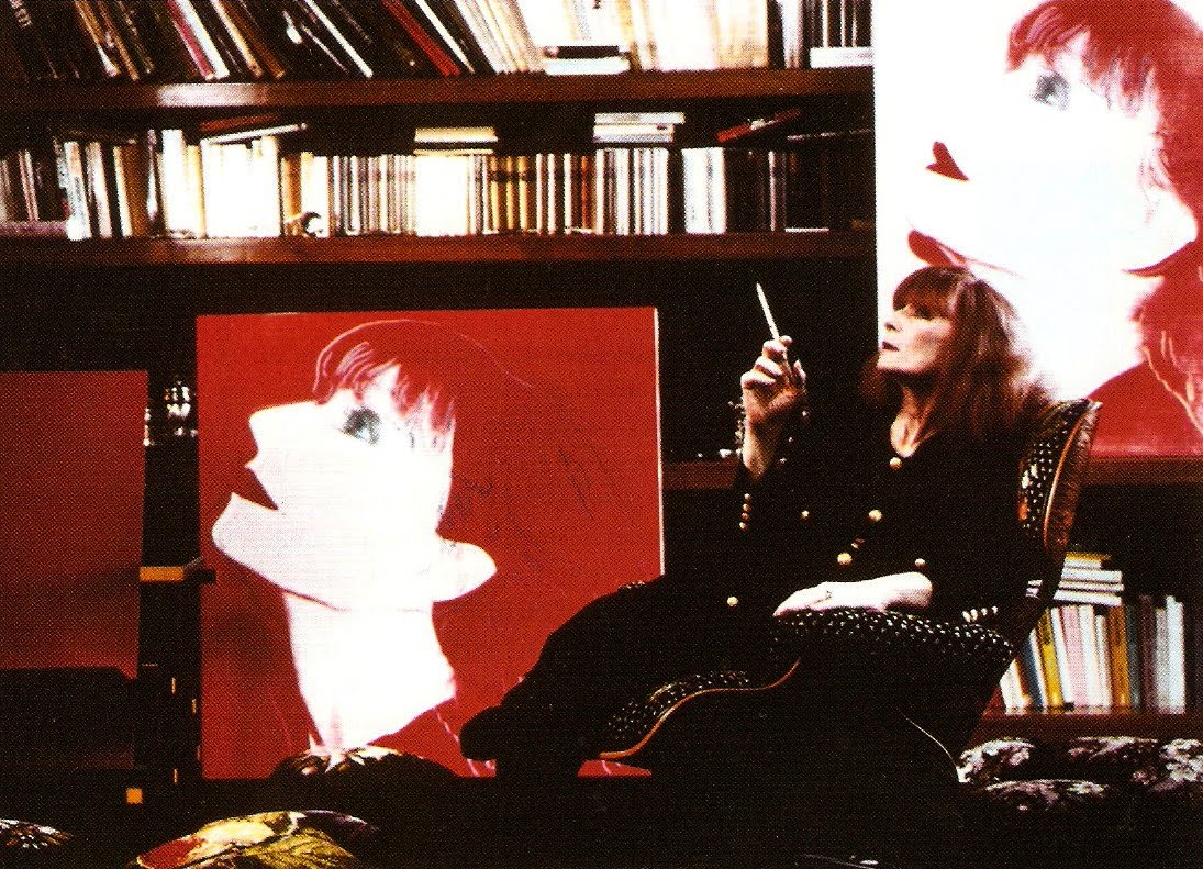 Sonia Rykiel at home along her Andy Warhol portraits