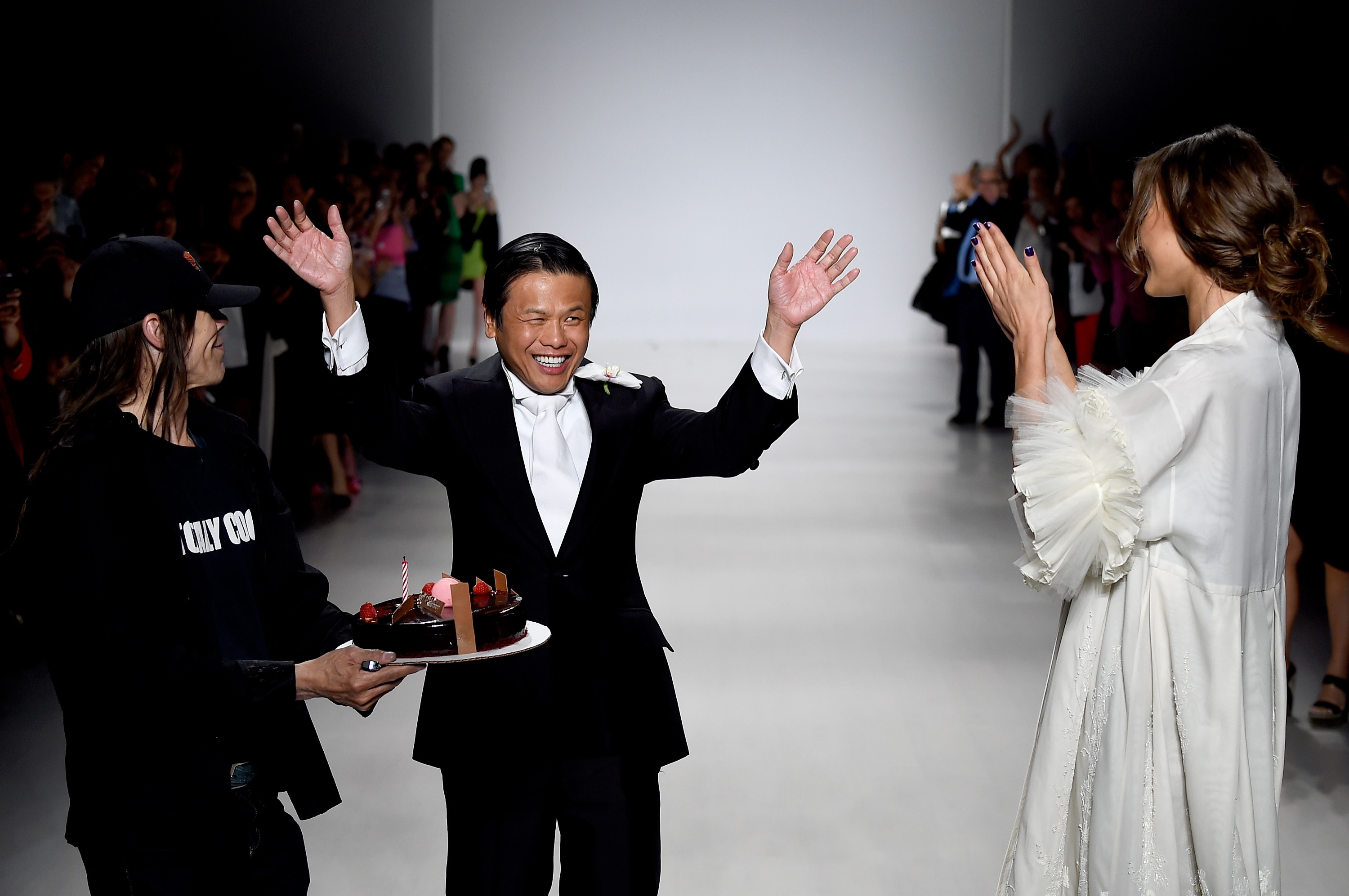 Zang Toi received an impromptu cake from the photographers to celebrate his 25th anniversary collection during Mercedes-Benz Fashion Week Spring 2015