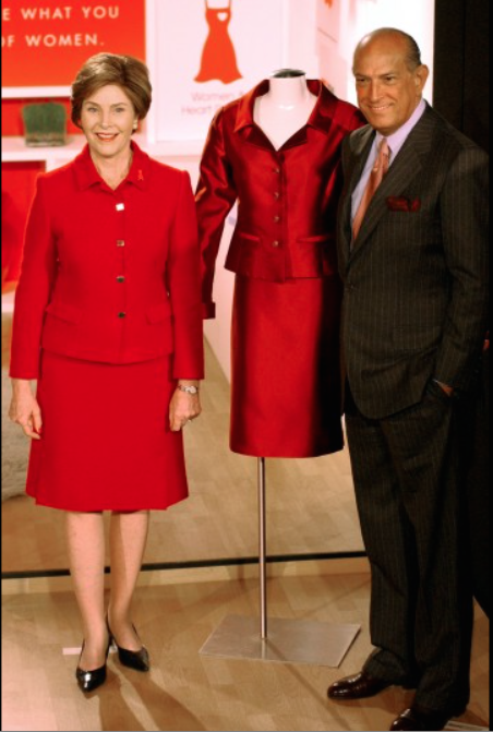 Laura Bush and Oscar de la Renta pose for photographers with an outfit she is donating to the Heart Truth 2004 collection in New York. The outfit was designed by de la Renta, Feb. 9, 2004