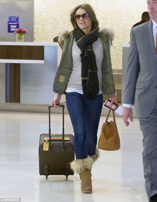 Liz Hurley wears fur-trimmed gilet and boots to match