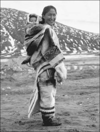 Inuit woman and baby. In many Arctic regions, a pouch is sewn onto the back of a woman's parka to hold her child
