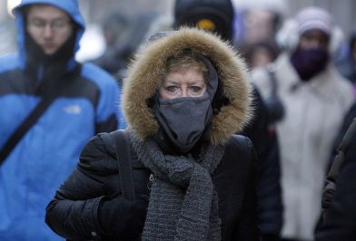 Morning commuters are seen bundled up Tuesday, Jan. 28, 2014, in Chicago. The National Weather Service is reporting the air temperature dropped to 11 degrees below zero at O'Hare International Airport and Midway International Airports on Tuesday morning. Cold temperatures have forced the cancellation of about 625 flights at Chicago's major airports. (AP Photo/Kiichiro Sato)