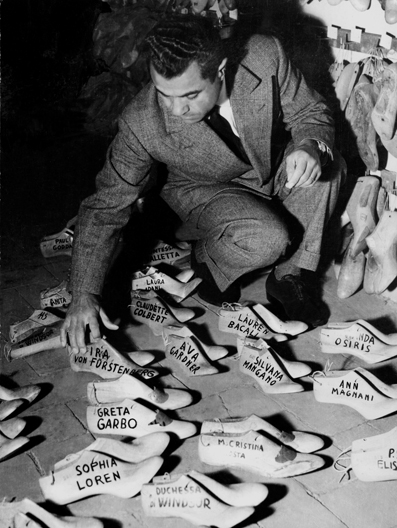 Salvatore Ferragamo surveying the foot forms of some of his famous celebrity clients 