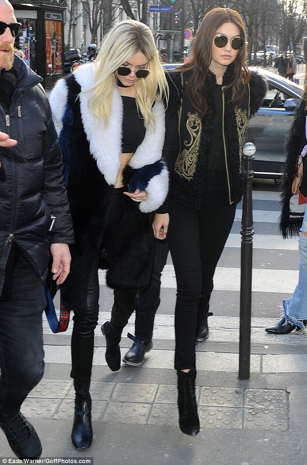 Kendall covered up with a statement fur coat while Gigi rocks a military-style jacket