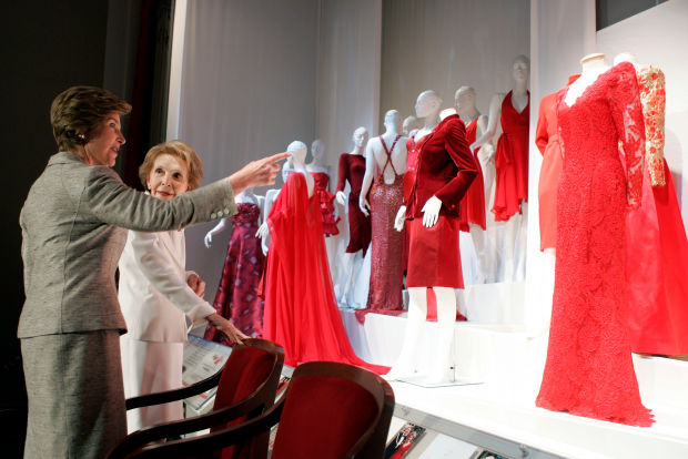 Laura Bush and Nancy Reagan discuss the red Oscar de la Renta dress Mrs. Reagan wore to a presidential dinner in 1998. Photo: Brendan Smialowski/Getty Images