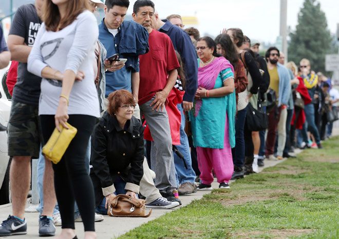 Americans exercising their civic duty and standing in line to cast their vote