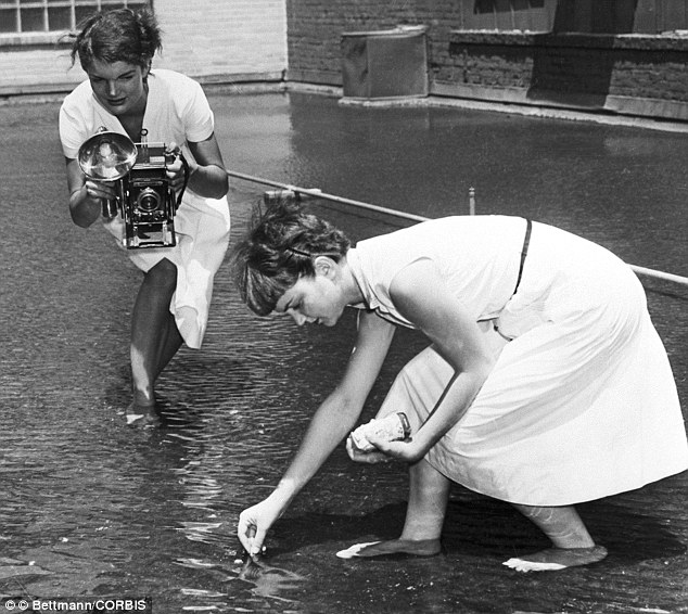 The future first Lady photographs Dale Chestnut feeding goldfish on the roof-