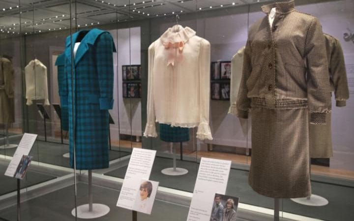 A green and black tartan wool day-suit worn by Princess Diana on a royal visit to Italy in 1985, a pale pink chiffon blouse worn for Diana's first official portrait in 1981 and a brown tweed wool day suit worn on her honeymoon in Balmoral in 1981, on display at the Diana: Her Fashion Story exhibition CREDIT: YUI MOK/PA WIRE