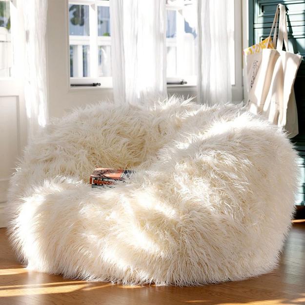 The popular poof silhouette is even more elevated in a natural Mongolian lamb fabrication home decor trends